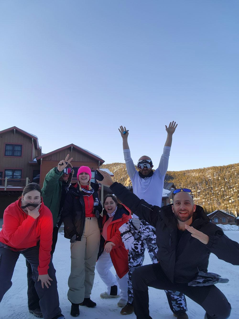 TRC members posing outside ski cabin