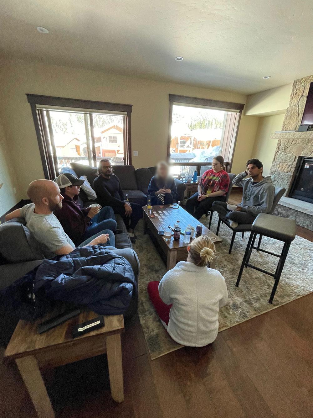 Students gathered in living room of ski cabin