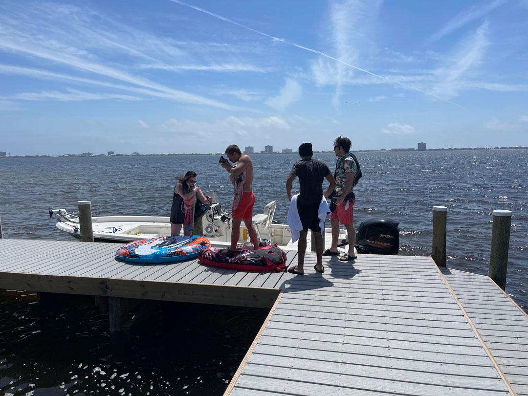 Students getting on boat from a pier in Pensacola