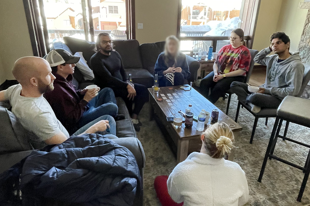 TRC members gathered in living room of ski cabin