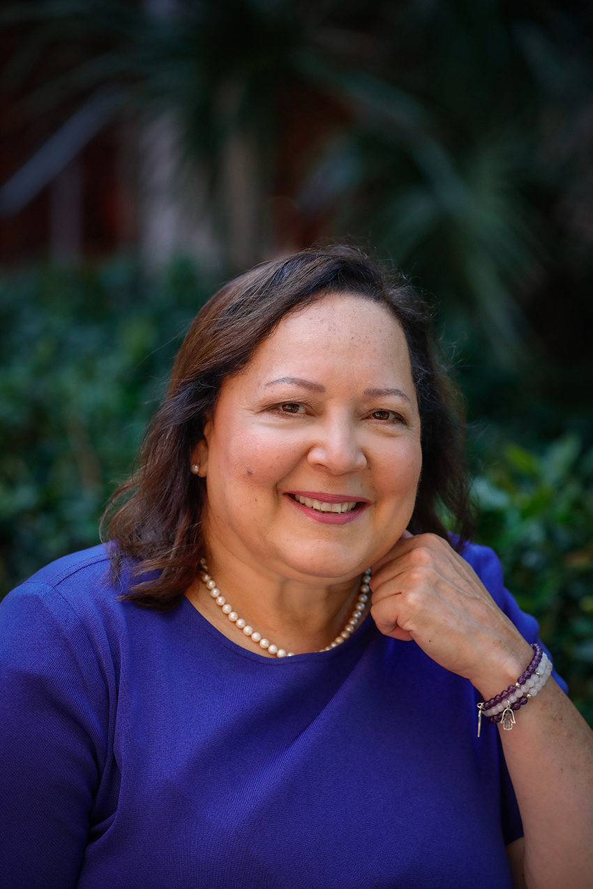 Portrait of Dr. Julie Morial smiling with her hand in a gentle fist against her face