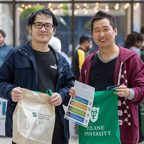 2 graduate students smiling with swag at the Downtown campus