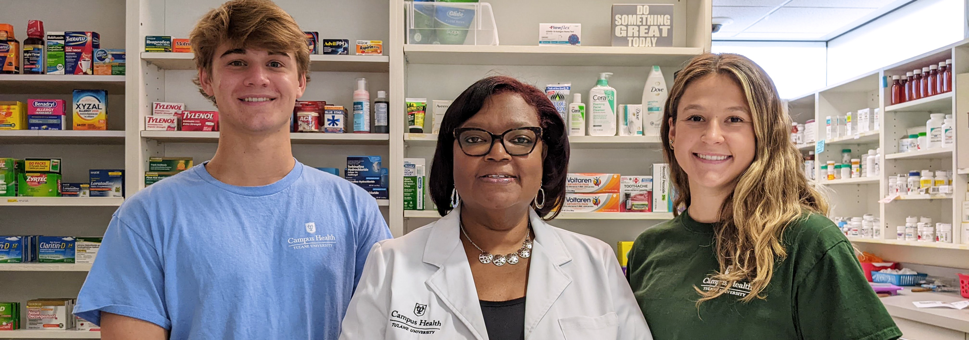 Pharmacist staff smiling from behind the pharmacy counter