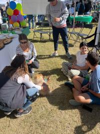 Students sitting outside during Homecoming tailgate