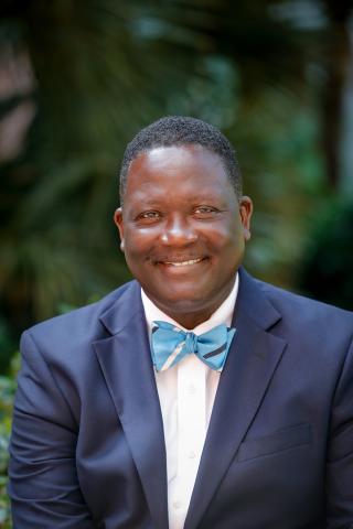 Portrait of Dr. Steven Byrd wear a dark blue vest with a light blue bowtie, gently smiling