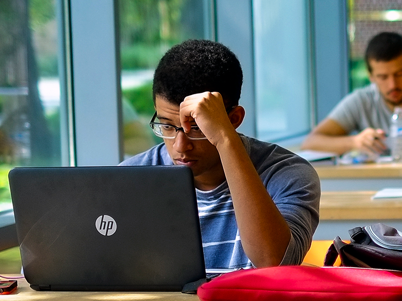 Stressed out Tulane student looking at laptop